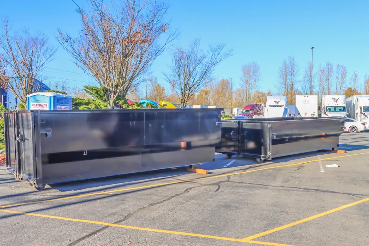 Professional dumpster rental service with roll-off container on residential driveway in Granbury